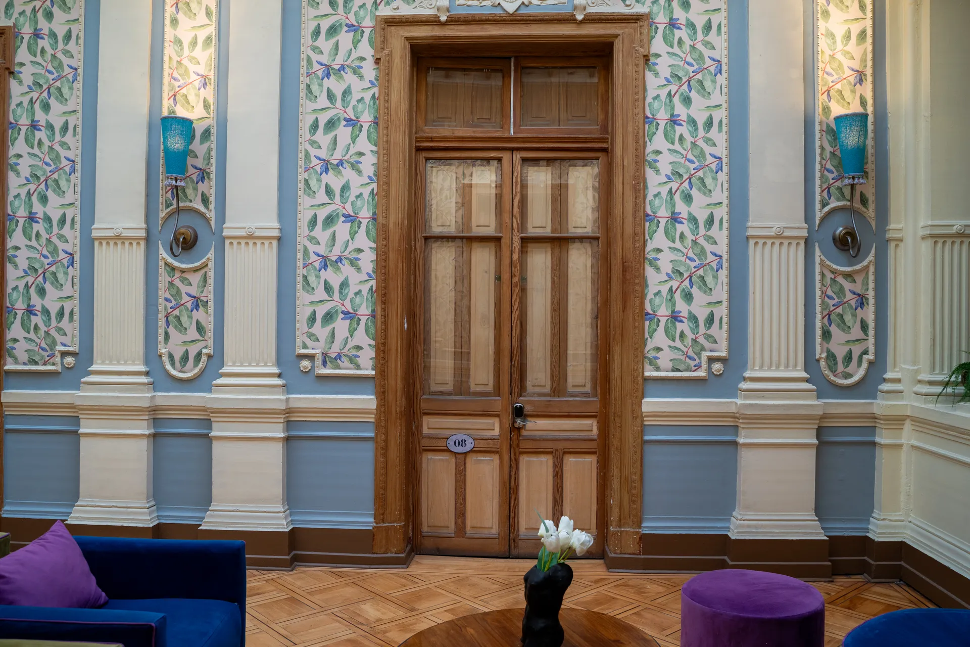 Happy Hostel grand entrance hall with original parquet floors, decorative moldings and heritage architectural details in Santiago Centro