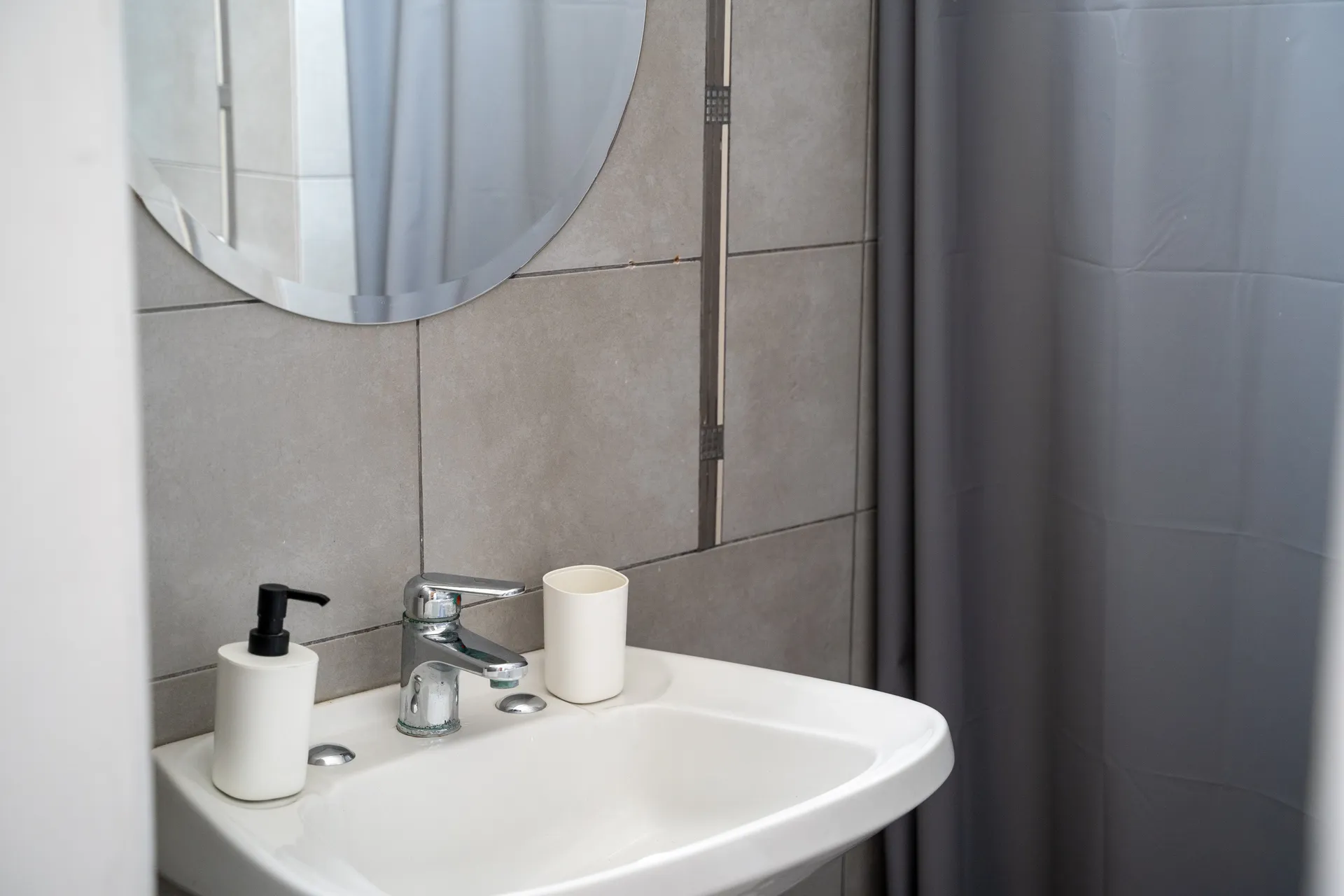 Deluxe double room with queen bed at Happy Hostel Santiago featuring original parquet floors and heritage decorative moldings